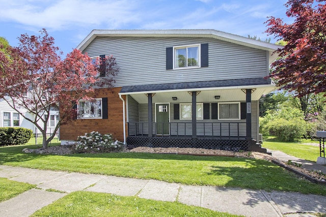 view of front of home with a porch and a front yard