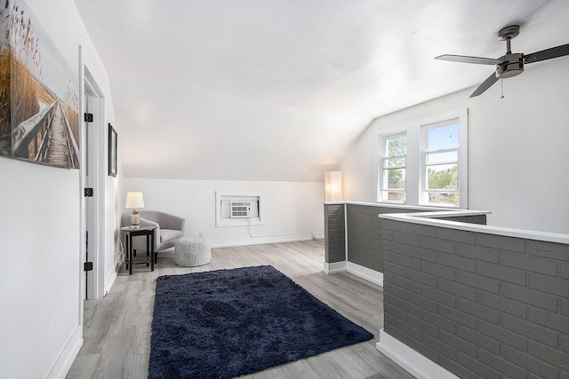 bedroom featuring light wood-style flooring, lofted ceiling, baseboards, and a ceiling fan