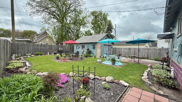 view of yard featuring a patio and an outdoor structure