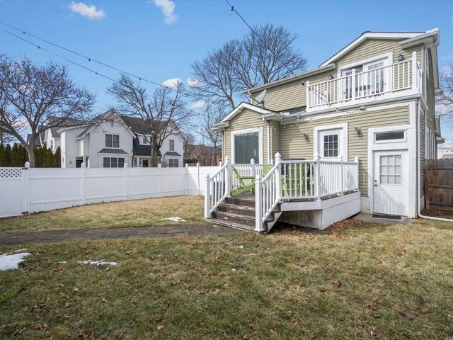 rear view of property featuring a balcony