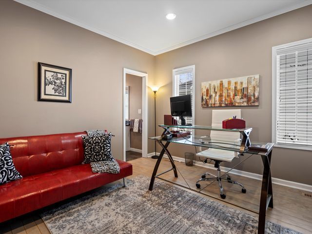 office space featuring crown molding, wood finished floors, recessed lighting, and baseboards