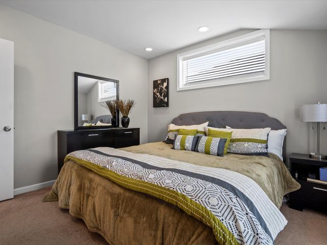 carpeted bedroom featuring recessed lighting and baseboards