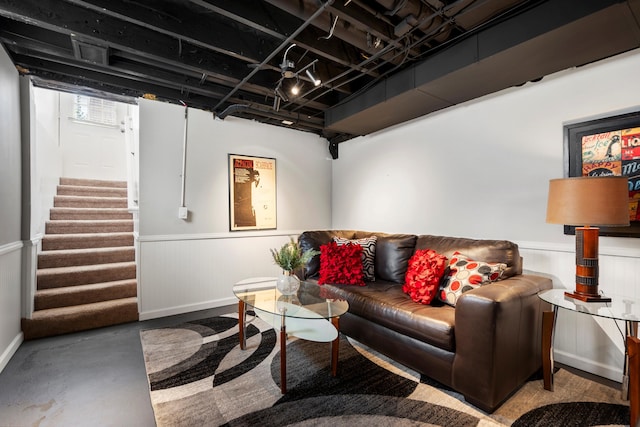 1106 Bennaville Ave, Birmingham, MI 48009 - living area featuring wainscoting, stairway, finished concrete flooring, and baseboards