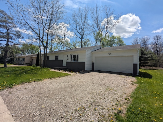 ranch-style house featuring driveway, a front lawn, and a garage