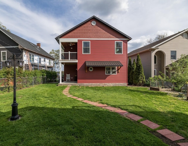 8811 Waruf Ave, Portage, MI 49002 - rear view of property with a balcony, a ceiling fan, and a vegetable garden
