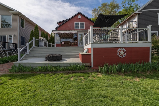 8811 Waruf Ave, Portage, MI 49002 - back of property with a wooden deck, a yard, and a fire pit