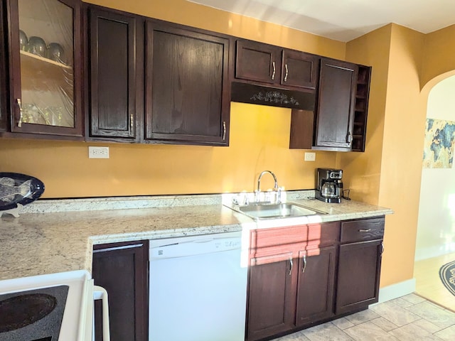 8811 Waruf Ave, Portage, MI 49002 - kitchen with dishwasher, dark brown cabinets, arched walkways, glass insert cabinets, and light stone counters