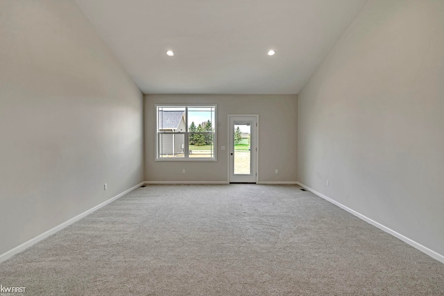 carpeted empty room with baseboards, recessed lighting, and vaulted ceiling