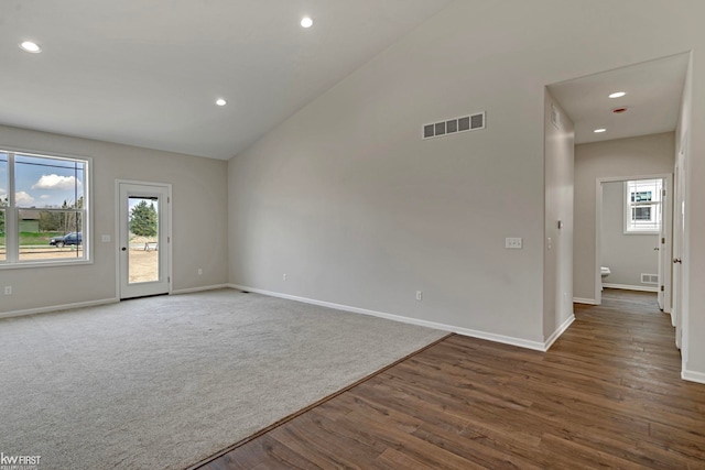 11146 Brahms Ln, Davison, MI 48423 - spare room with healthy amount of natural light, baseboards, lofted ceiling, wood finished floors, and recessed lighting