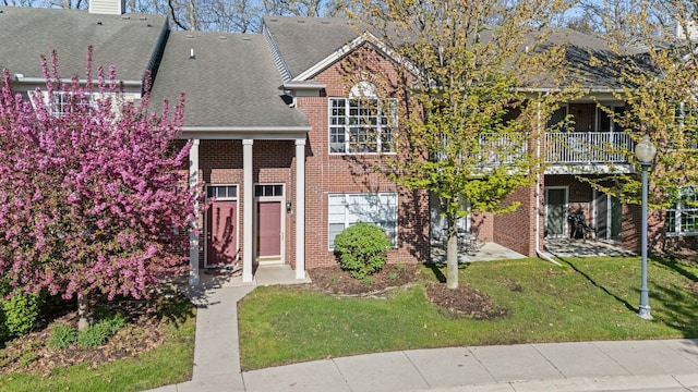 1708 Deepwood Cir, Rochester, MI 48307 - view of front facade featuring brick siding, a front lawn, roof with shingles, and a chimney
