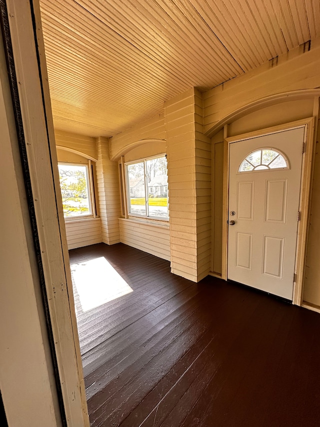 foyer entrance with wooden ceiling and dark wood finished floors