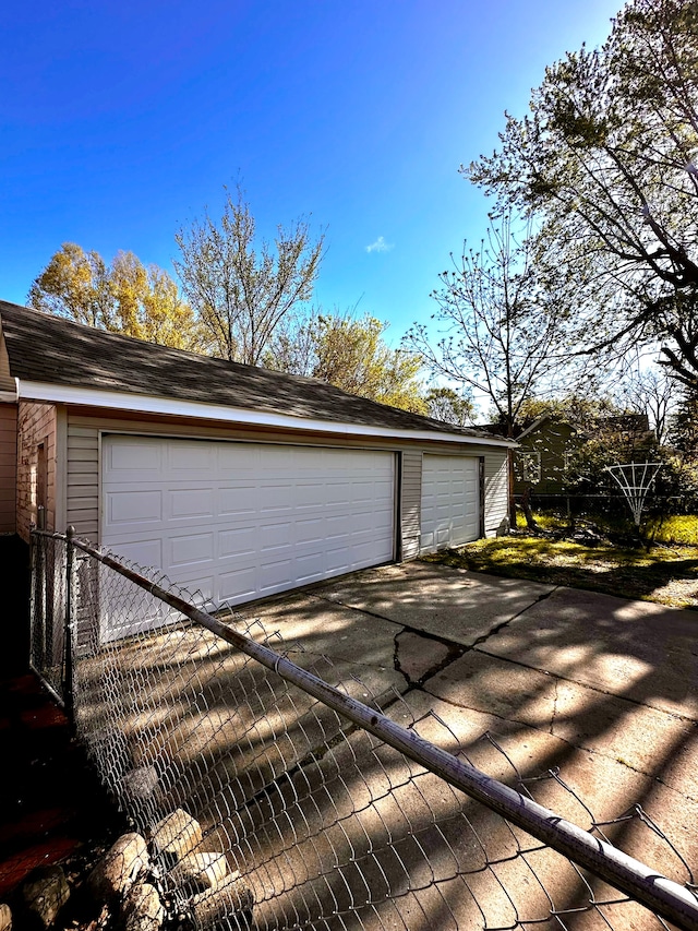 detached garage featuring fence