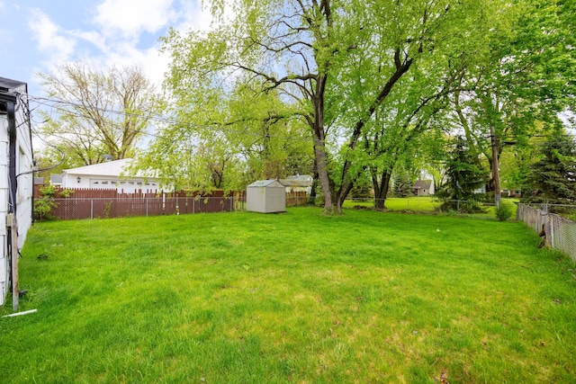 view of yard featuring a storage shed and an outbuilding