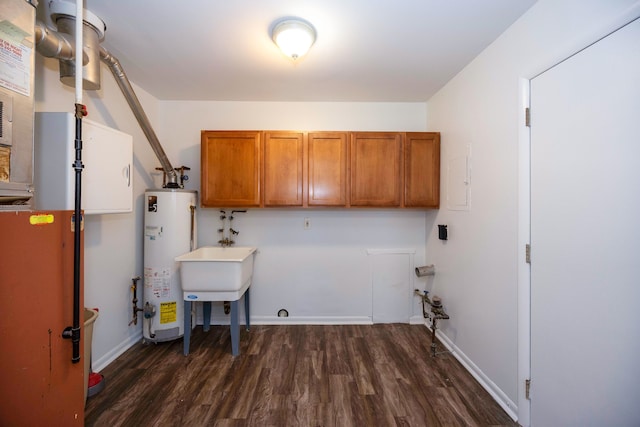 laundry area with gas water heater, cabinet space, dark wood-style floors, and baseboards