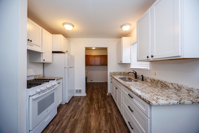 kitchen featuring white range with gas stovetop, a sink, under cabinet range hood, dark wood-style floors, and white cabinets