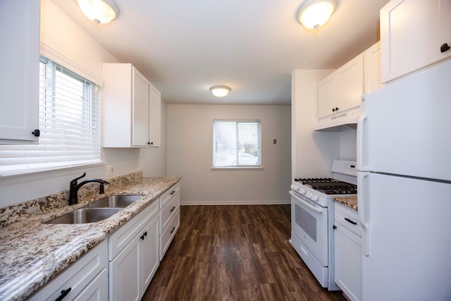 kitchen featuring white appliances, a sink, under cabinet range hood, dark wood-style flooring, and white cabinets