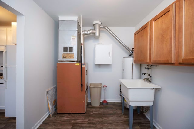 laundry room featuring dark wood-type flooring and baseboards