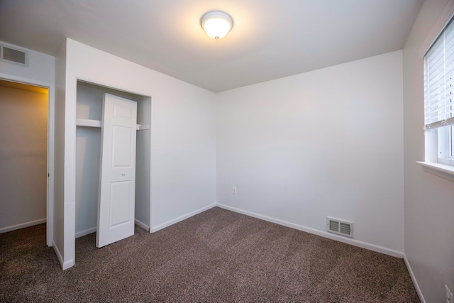 unfurnished bedroom featuring carpet flooring and baseboards