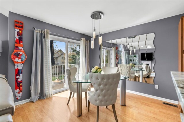 dining space featuring wood finished floors and baseboards