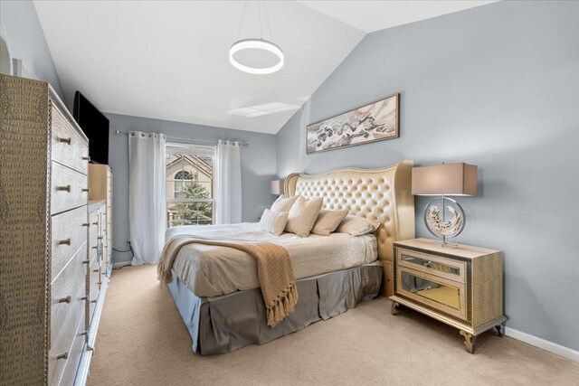 carpeted bedroom featuring vaulted ceiling and baseboards