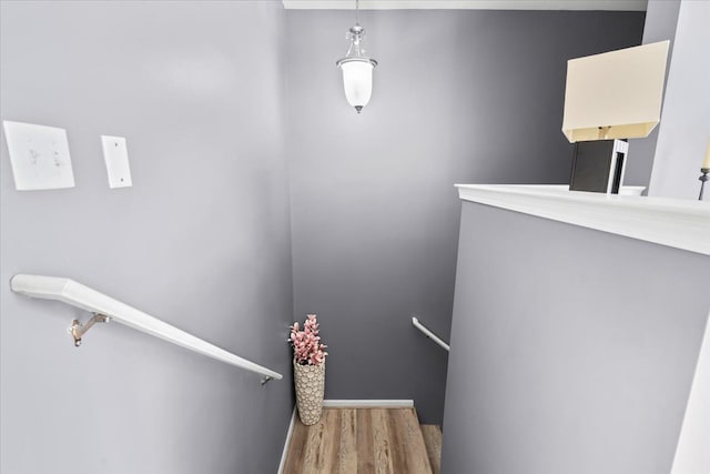 stairs with wood finished floors and baseboards