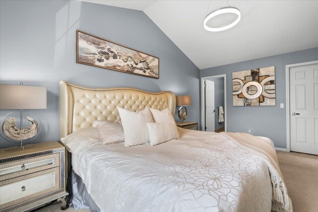 carpeted bedroom featuring vaulted ceiling