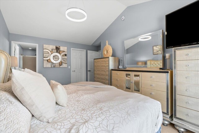bedroom with lofted ceiling and carpet