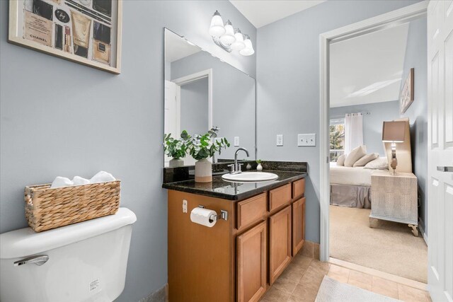bathroom featuring vanity, toilet, and tile patterned flooring