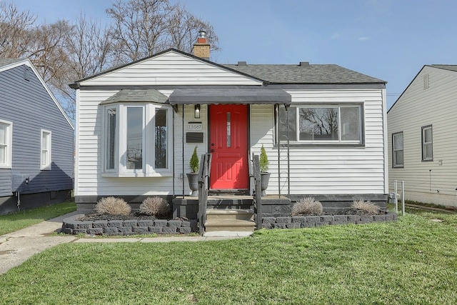 11067 Paige Ave, Warren, MI 48089 - view of front of property featuring a front lawn and a chimney