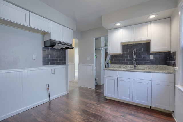 11067 Paige Ave, Warren, MI 48089 - kitchen with a sink, under cabinet range hood, wainscoting, dark wood-type flooring, and white cabinetry