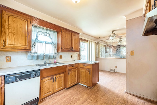 kitchen with dishwasher, light countertops, a ceiling fan, brown cabinetry, and light wood-type flooring