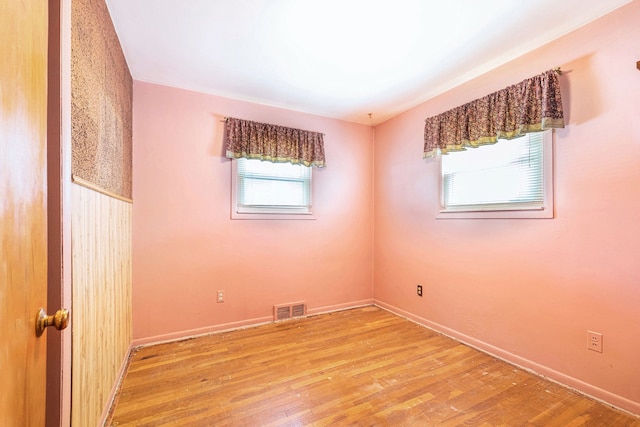 unfurnished room with light wood-type flooring and baseboards