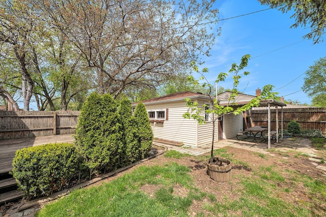 fenced backyard with an outdoor structure and a patio area