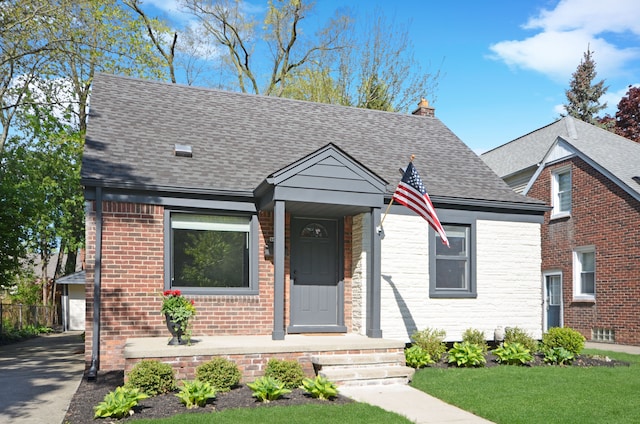 3023 N Vermont Ave, Royal Oak, MI 48073 - view of front of property with roof with shingles, a chimney, a front lawn, and brick siding