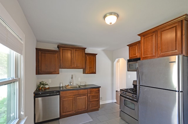 3023 N Vermont Ave, Royal Oak, MI 48073 - kitchen with appliances with stainless steel finishes, a sink, dark countertops, and brown cabinetry