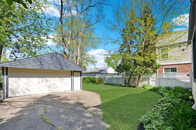 view of yard featuring an outbuilding and a detached garage
