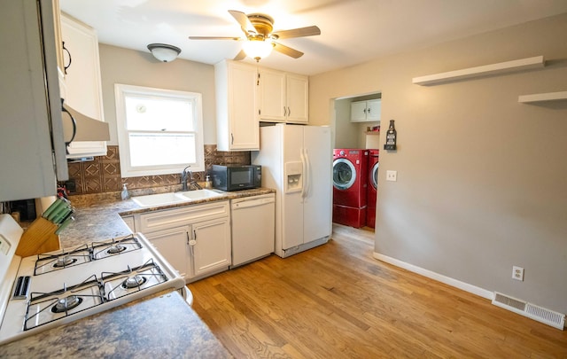 1291 103rd Ave, Plainwell, MI 49080 - kitchen featuring washer and clothes dryer, white appliances, a sink, decorative backsplash, and a ceiling fan