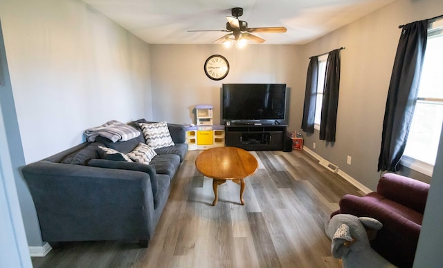 1291 103rd Ave, Plainwell, MI 49080 - living room featuring healthy amount of natural light, wood finished floors, ceiling fan, and baseboards