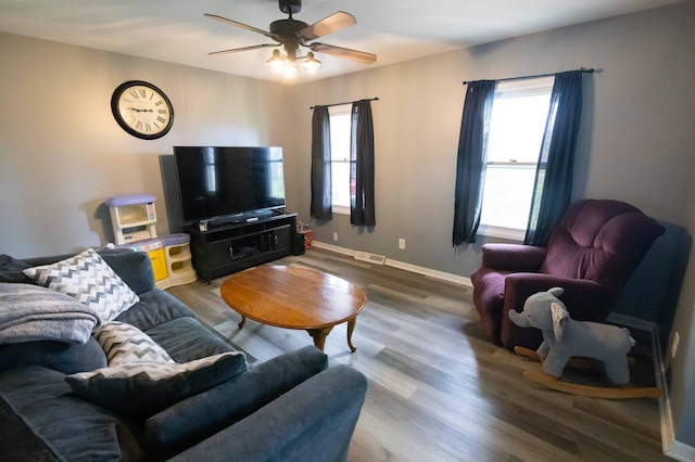 1291 103rd Ave, Plainwell, MI 49080 - living room featuring a ceiling fan, wood finished floors, and baseboards