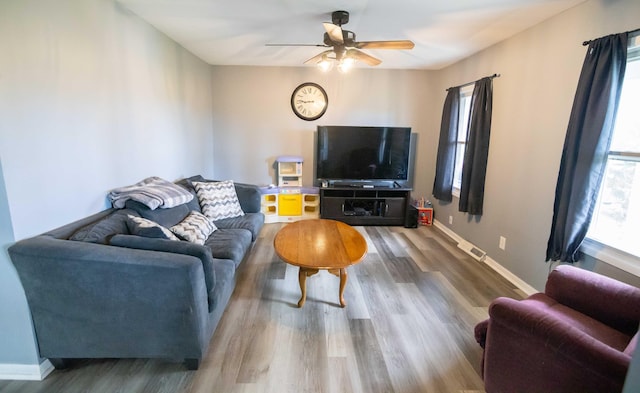 1291 103rd Ave, Plainwell, MI 49080 - living area featuring wood finished floors, ceiling fan, and baseboards