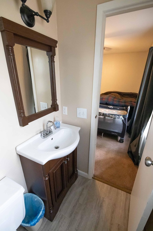 1291 103rd Ave, Plainwell, MI 49080 - bathroom featuring vanity, wood finished floors, and toilet