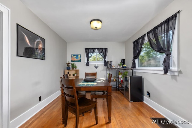 dining room featuring baseboards and light wood-style floors