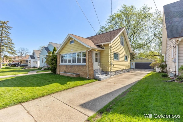 bungalow-style house featuring an outdoor structure, a garage, entry steps, and a front yard