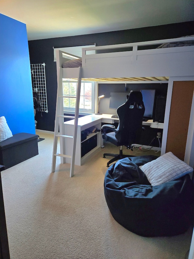 bedroom with carpet flooring and an office area