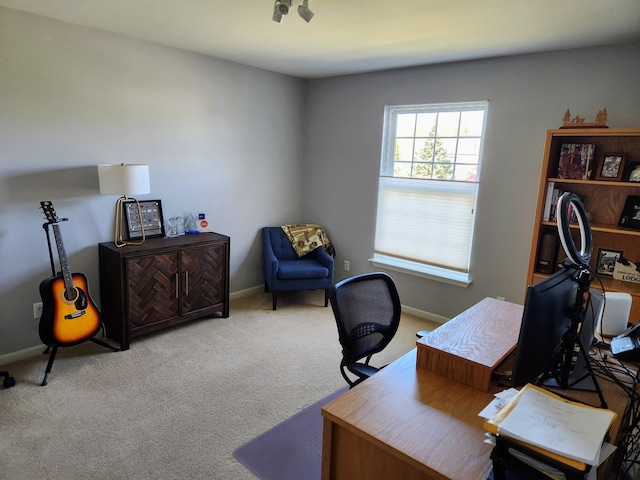 carpeted office space with baseboards
