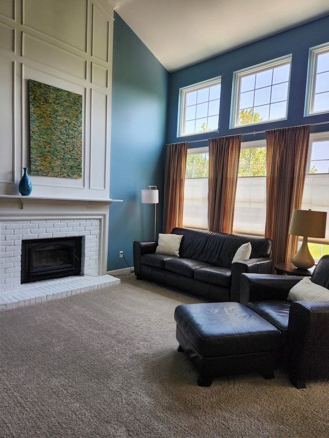 carpeted living area with a fireplace