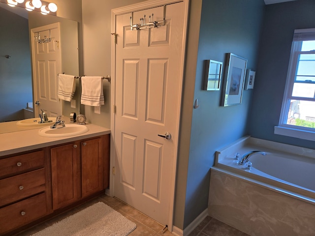 bathroom featuring tile patterned floors, vanity, and a garden tub