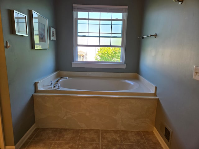 full bathroom featuring tile patterned floors and a bath