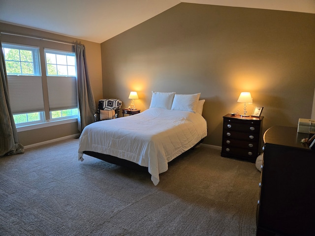 carpeted bedroom featuring vaulted ceiling, multiple windows, and baseboards