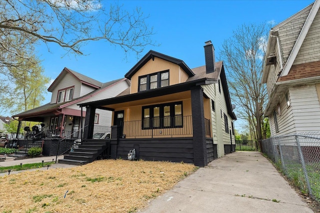 475 Algonquin St, Detroit, MI 48215 - view of front of home with a chimney, a porch, fence, and roof with shingles